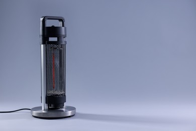 Photo of Modern electric heater on light grey background, space for text