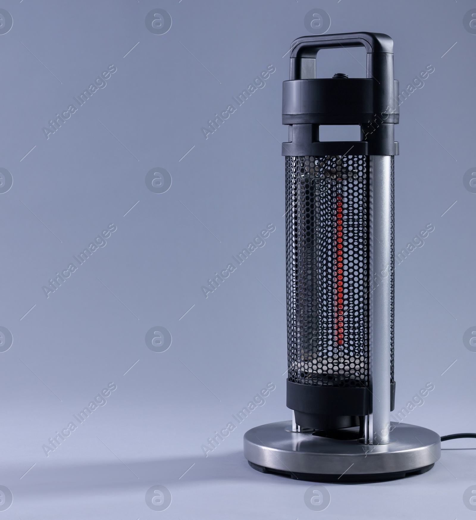 Photo of Modern electric heater on light grey background, space for text