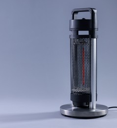 Photo of Modern electric heater on light grey background, space for text