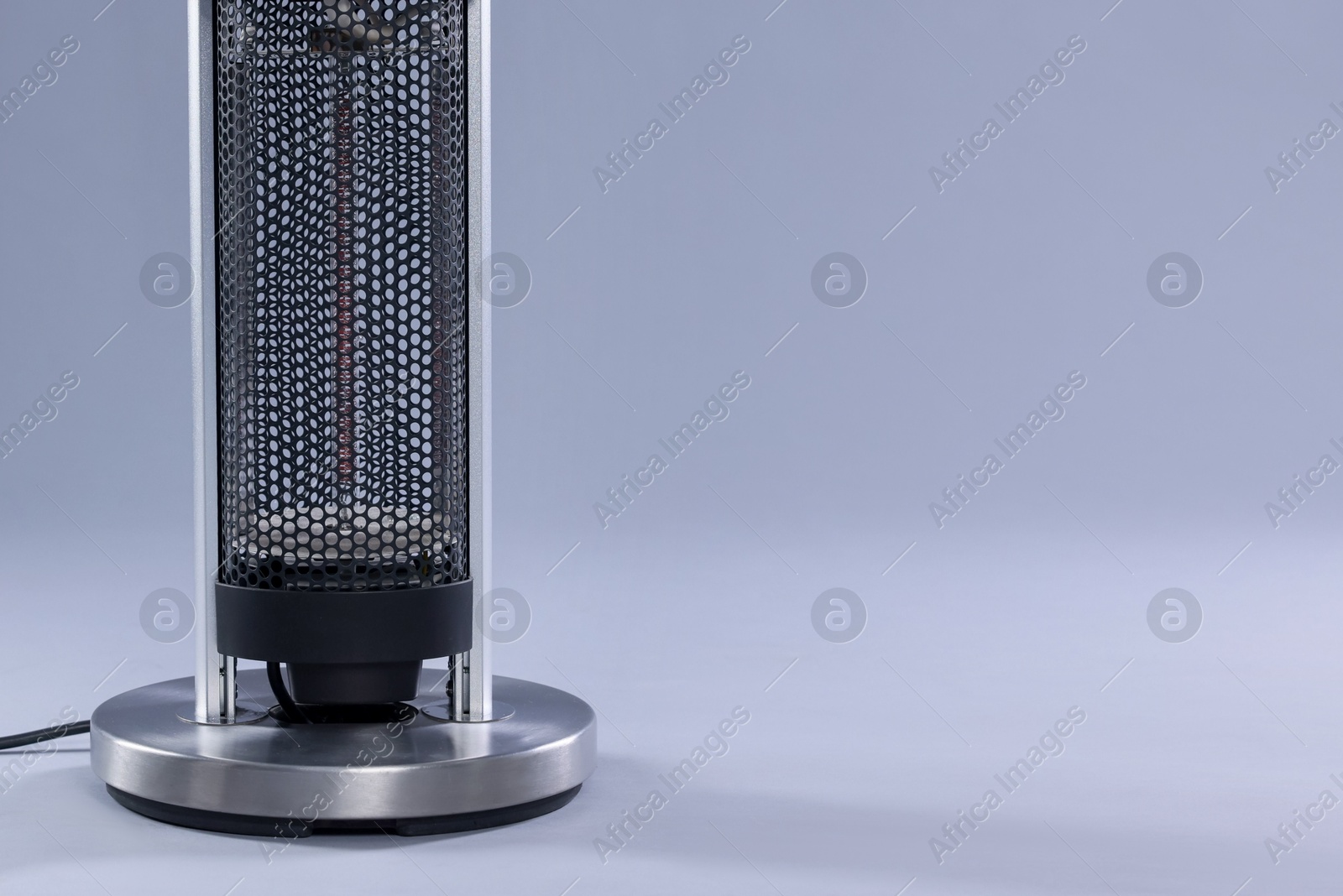 Photo of Modern electric heater on light grey background, closeup. Space for text