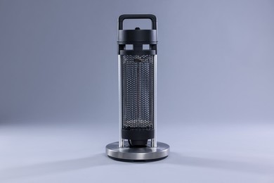 Photo of Modern electric heater on light grey background