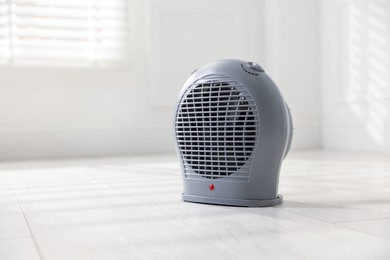 Photo of Modern electric fan heater at home, space for text