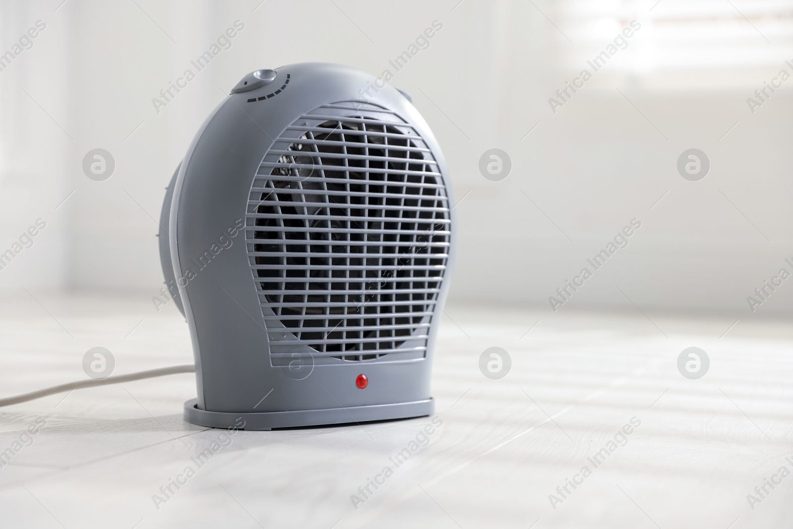 Photo of Modern electric fan heater at home, space for text