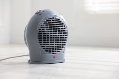 Photo of Modern electric fan heater at home, space for text
