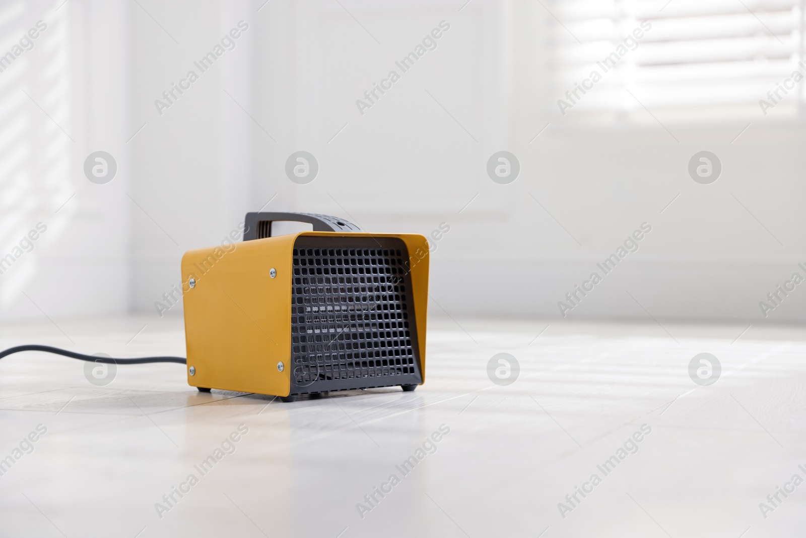 Photo of Modern electric fan heater at home, space for text