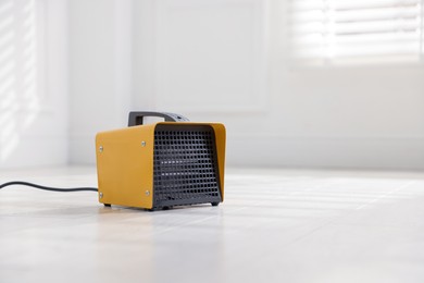 Photo of Modern electric fan heater at home, space for text