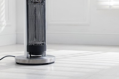 Photo of Modern electric heater at home, closeup. Space for text