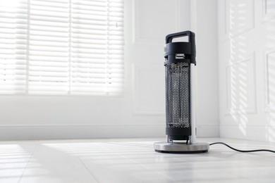 Photo of Modern electric heater at home, space for text