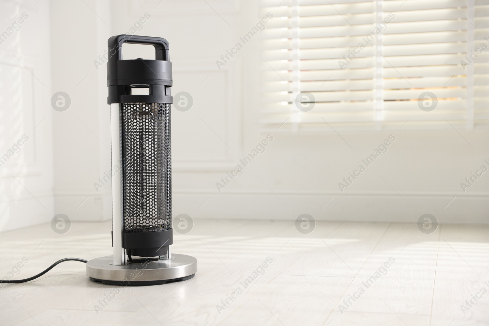 Photo of Modern electric heater at home, space for text