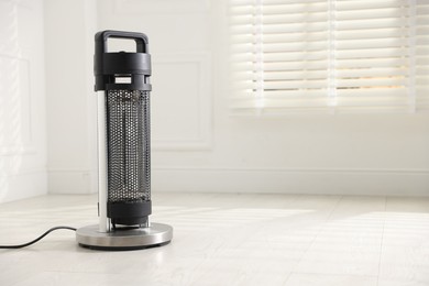 Photo of Modern electric heater at home, space for text