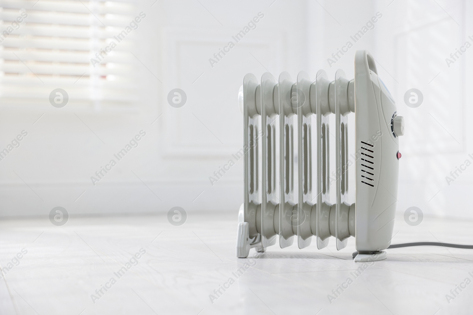 Photo of Modern electric heater at home, space for text