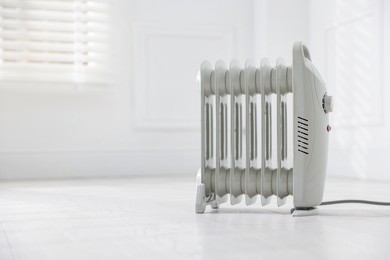 Photo of Modern electric heater at home, space for text