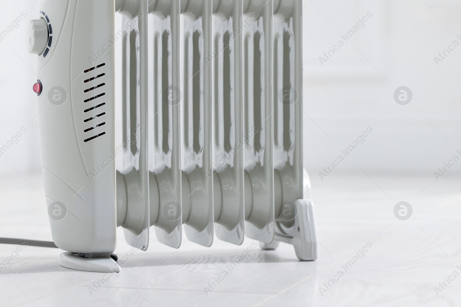 Photo of Modern electric heater at home, closeup. Space for text
