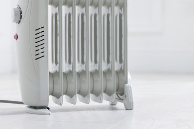 Photo of Modern electric heater at home, closeup. Space for text