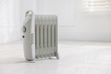 Photo of Modern electric heater at home, space for text