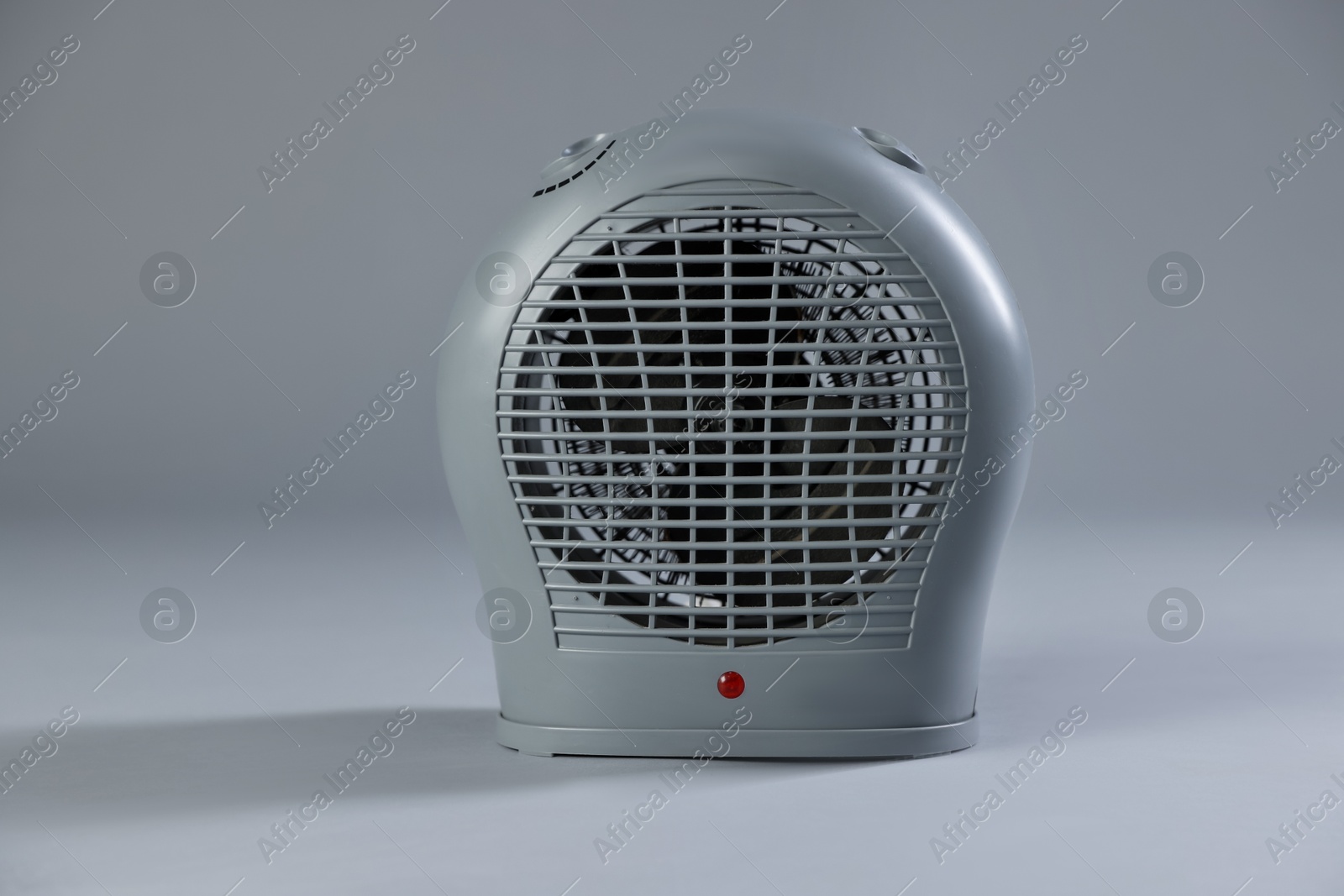 Photo of Modern electric fan heater on light grey background