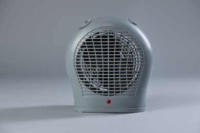 Photo of Modern electric fan heater on light grey background