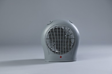 Photo of Modern electric fan heater on light grey background