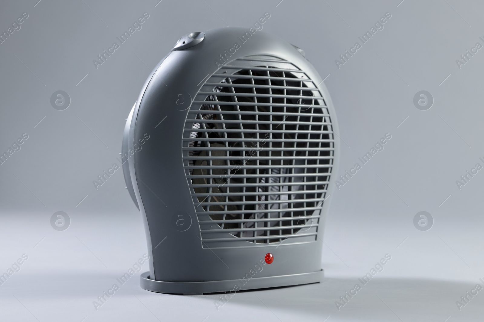 Photo of Modern electric fan heater on light grey background