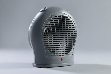 Photo of Modern electric fan heater on light grey background