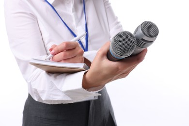 Photo of Journalist with microphones taking notes on white background, closeup