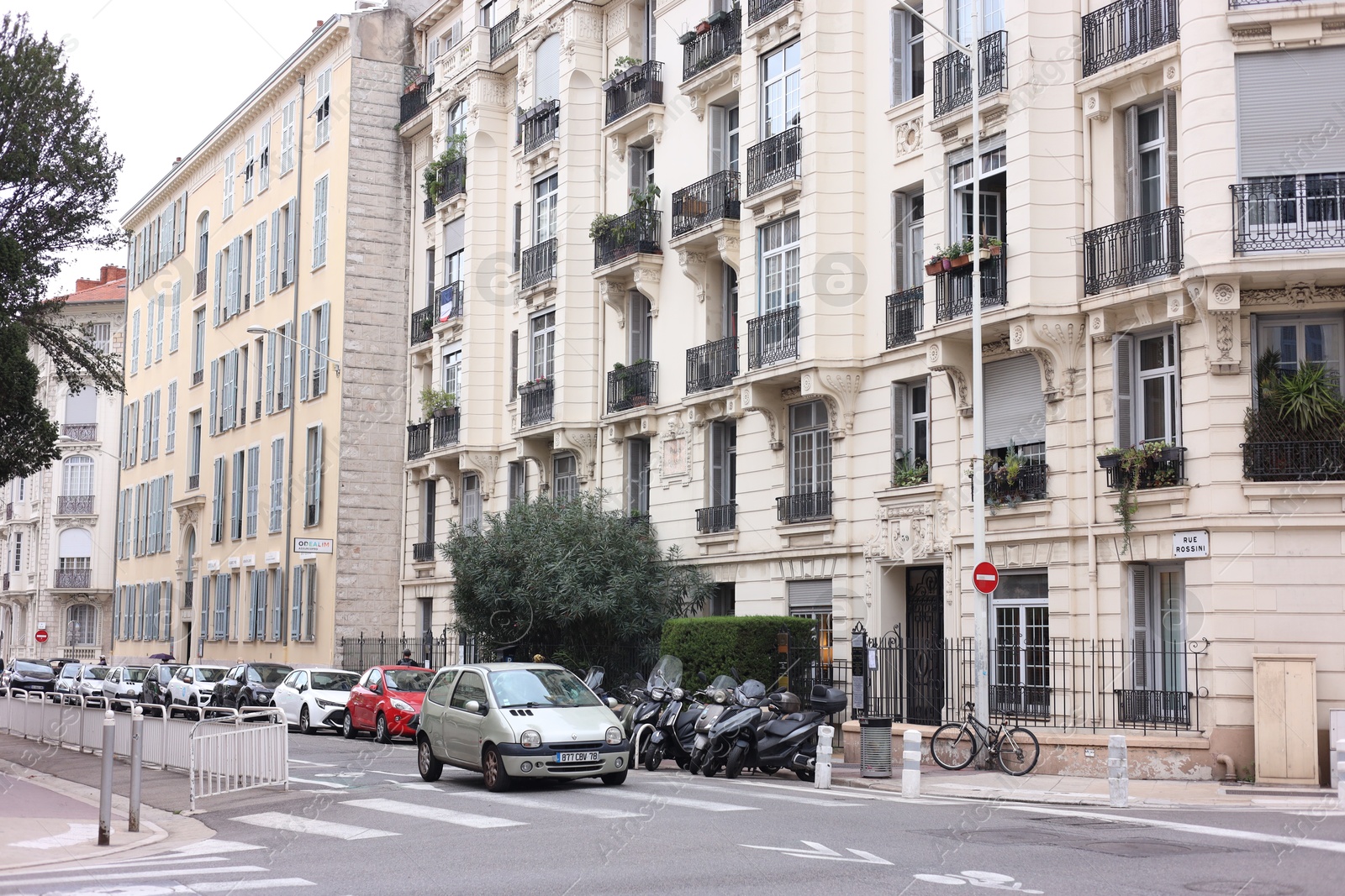 Photo of Nice, France - September 1, 2025: Beautiful building and parked cars in city