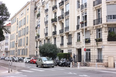 Photo of Nice, France - September 1, 2025: Beautiful building and parked cars in city