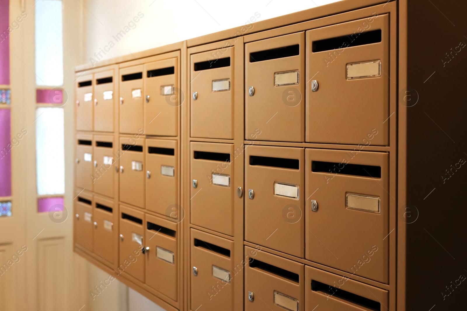 Photo of Many metal mailboxes with keyholes at post office