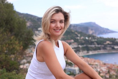 Photo of Beautiful young woman in stylish clothes outdoors