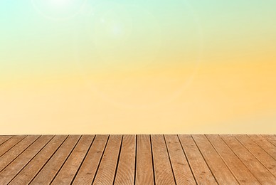 Image of Empty wooden floor and color gradient wall. Space for design