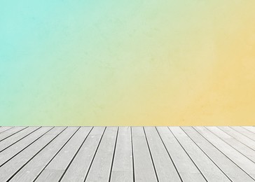 Image of Empty wooden floor and color gradient wall. Space for design