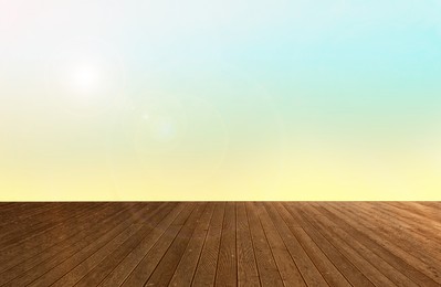 Image of Empty wooden floor and color gradient wall. Space for design
