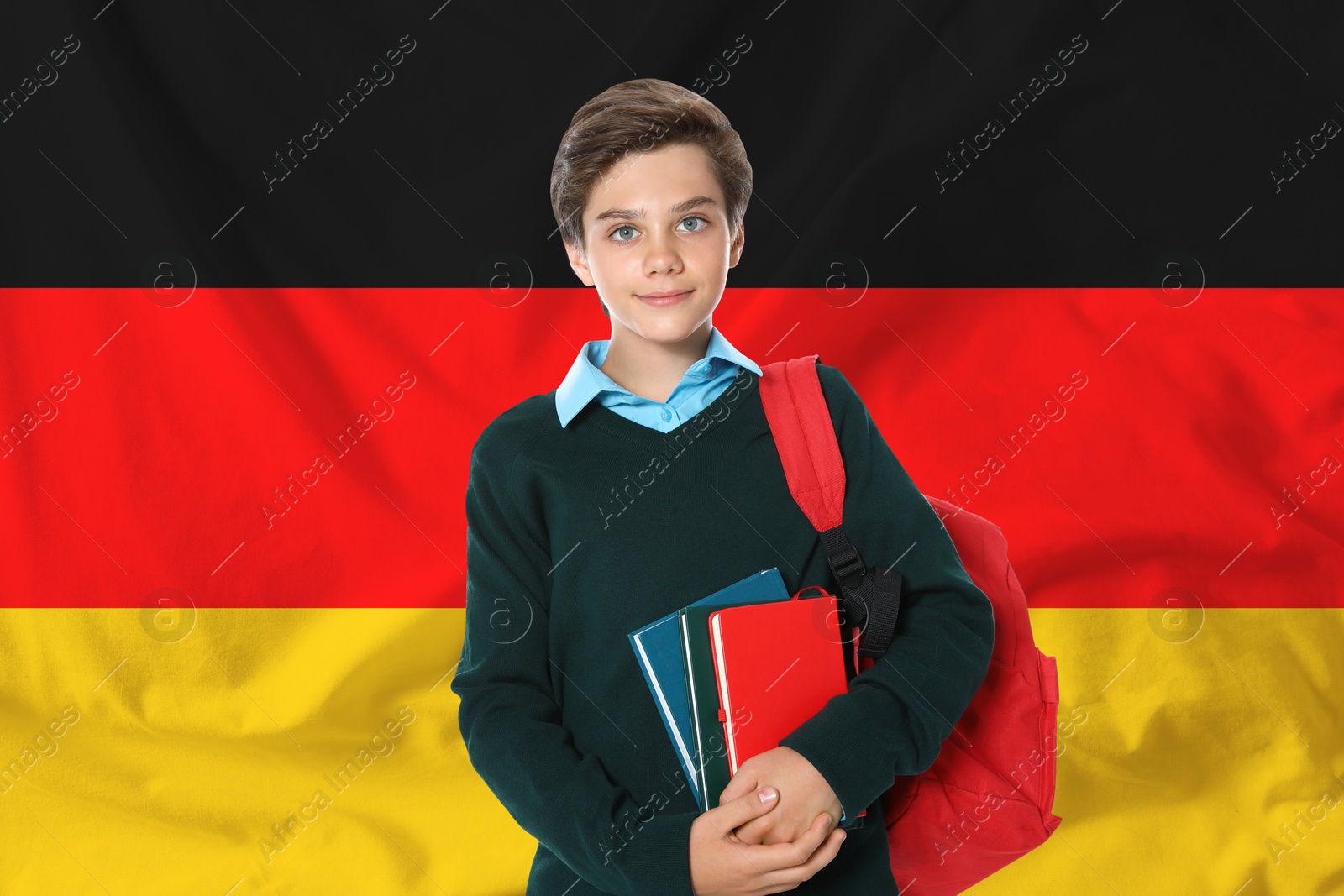 Image of Student with backpack and notebooks against flag of Germany. Language school