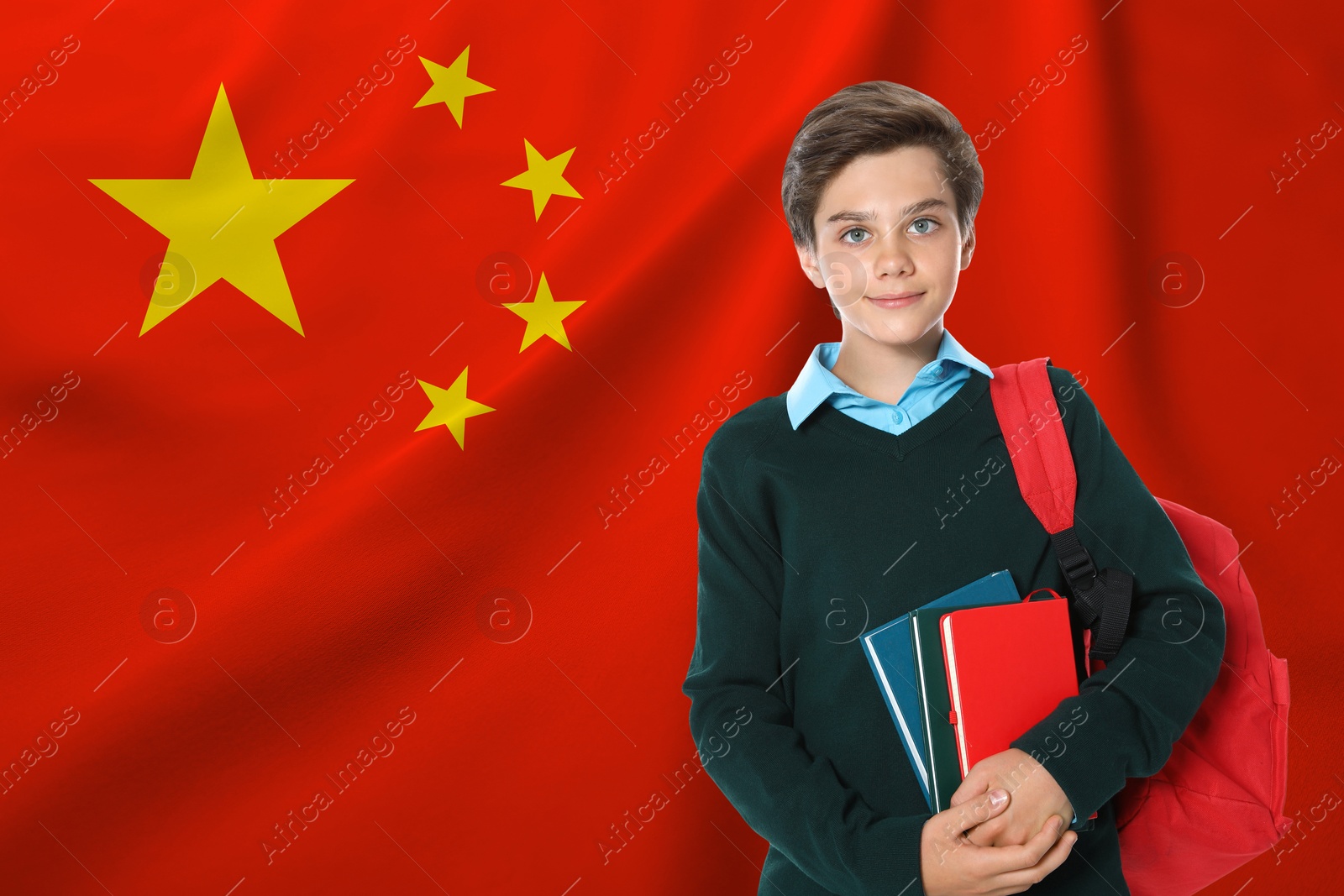 Image of Student with backpack and notebooks against flag of China. Language school