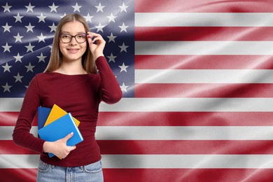 Image of Student with eyeglasses and notebooks against flag of USA. Language school