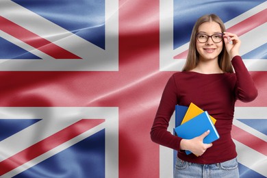 Image of Student with eyeglasses and notebooks against flag of United Kingdom. Language school