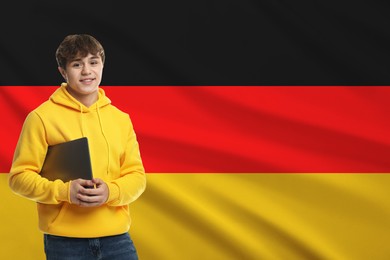 Image of Student with laptop against flag of Germany. Language school
