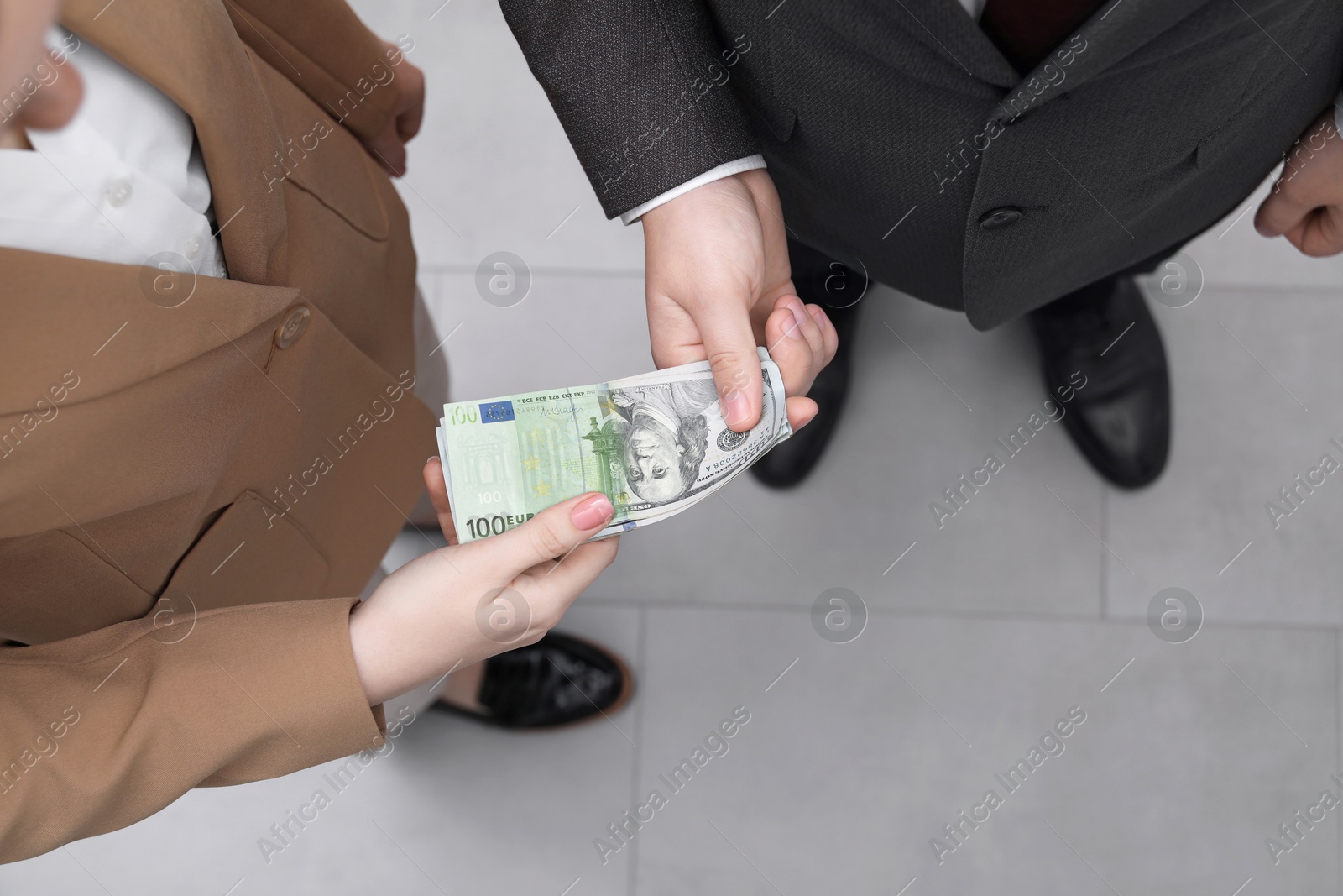 Image of Money exchange. Man and woman holding banknotes, closeup. Upper bill changing from dollar to euro