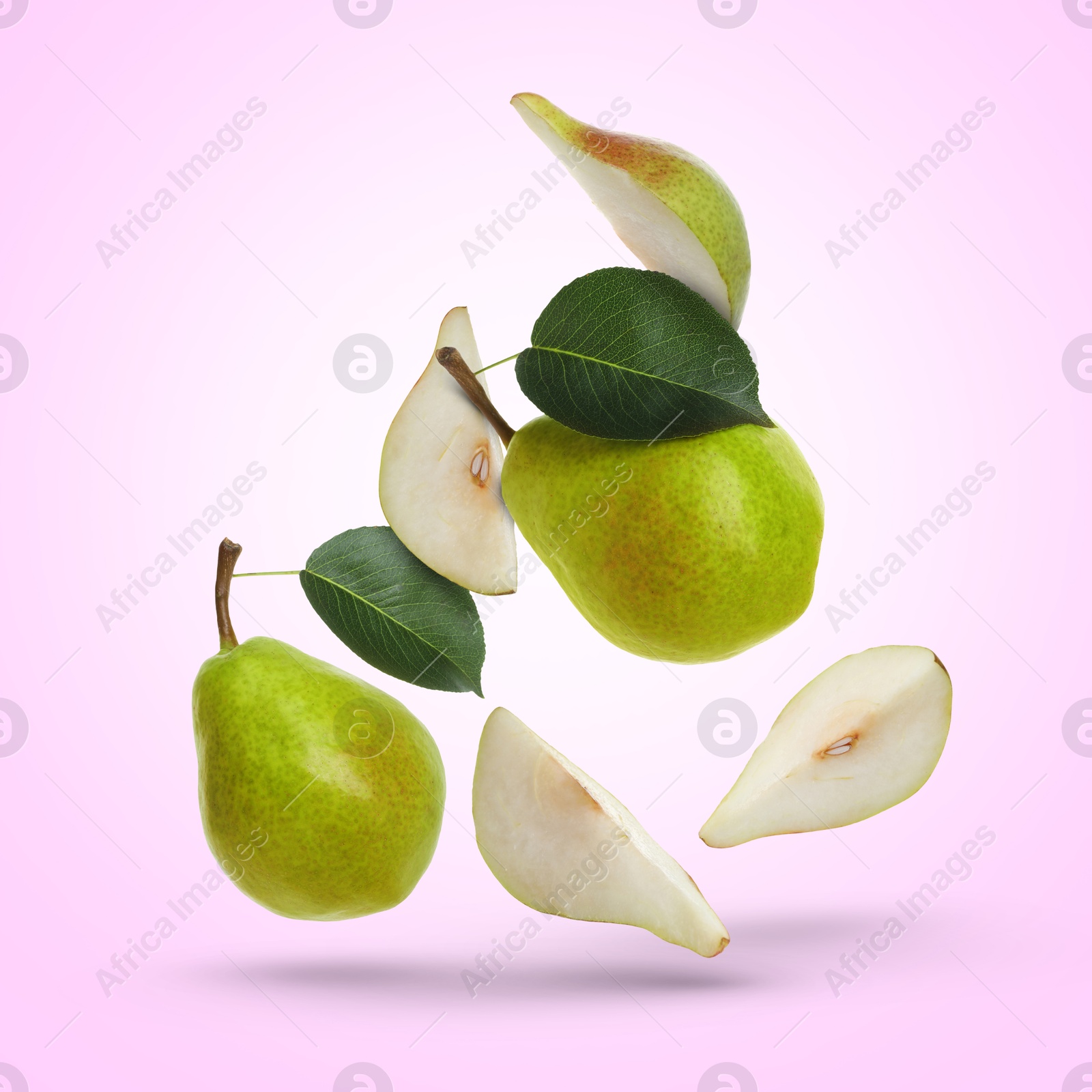 Image of Fresh green pears flying in air on light violet background