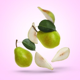 Image of Fresh green pears flying in air on light violet background