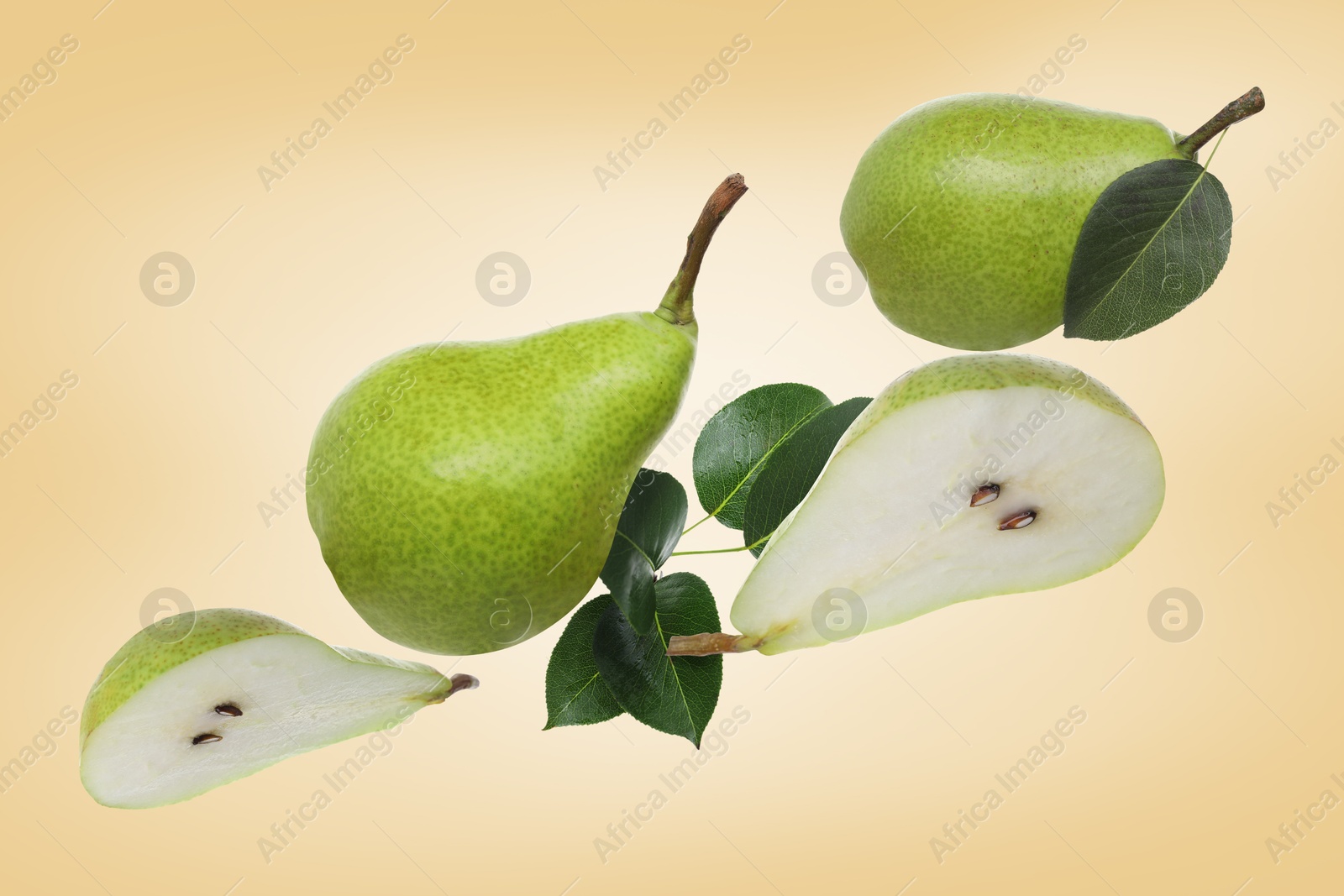 Image of Fresh green pears flying in air on pale orange background
