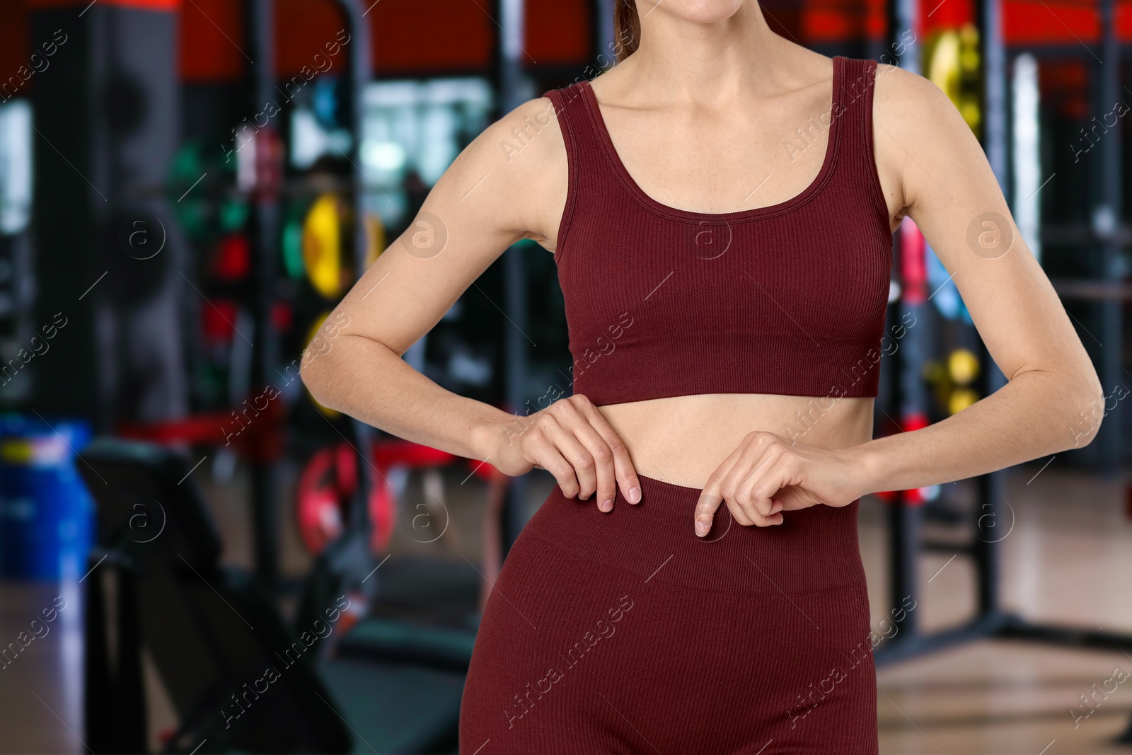 Image of Athletic woman with flat belly in gym, closeup