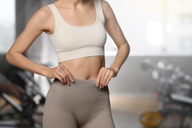 Image of Athletic woman with flat belly in gym, closeup