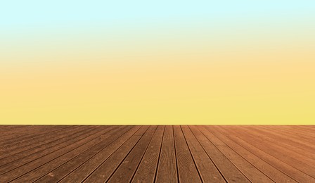 Image of Empty wooden floor and color gradient wall. Space for design