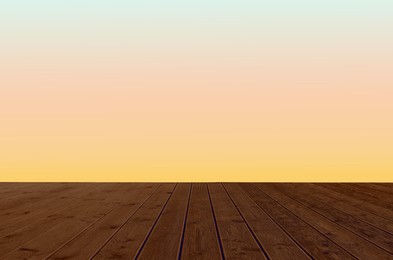 Image of Empty wooden floor and color gradient wall. Space for design