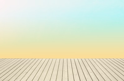 Image of Empty wooden floor and color gradient wall. Space for design