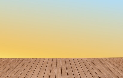 Image of Empty wooden floor and color gradient wall. Space for design
