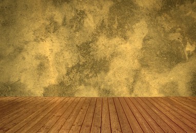 Image of Empty wooden floor and color textured wall. Space for design