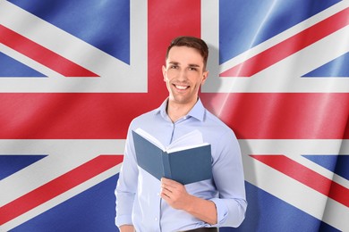 Image of Student or teacher with book against flag of United Kingdom. Language school