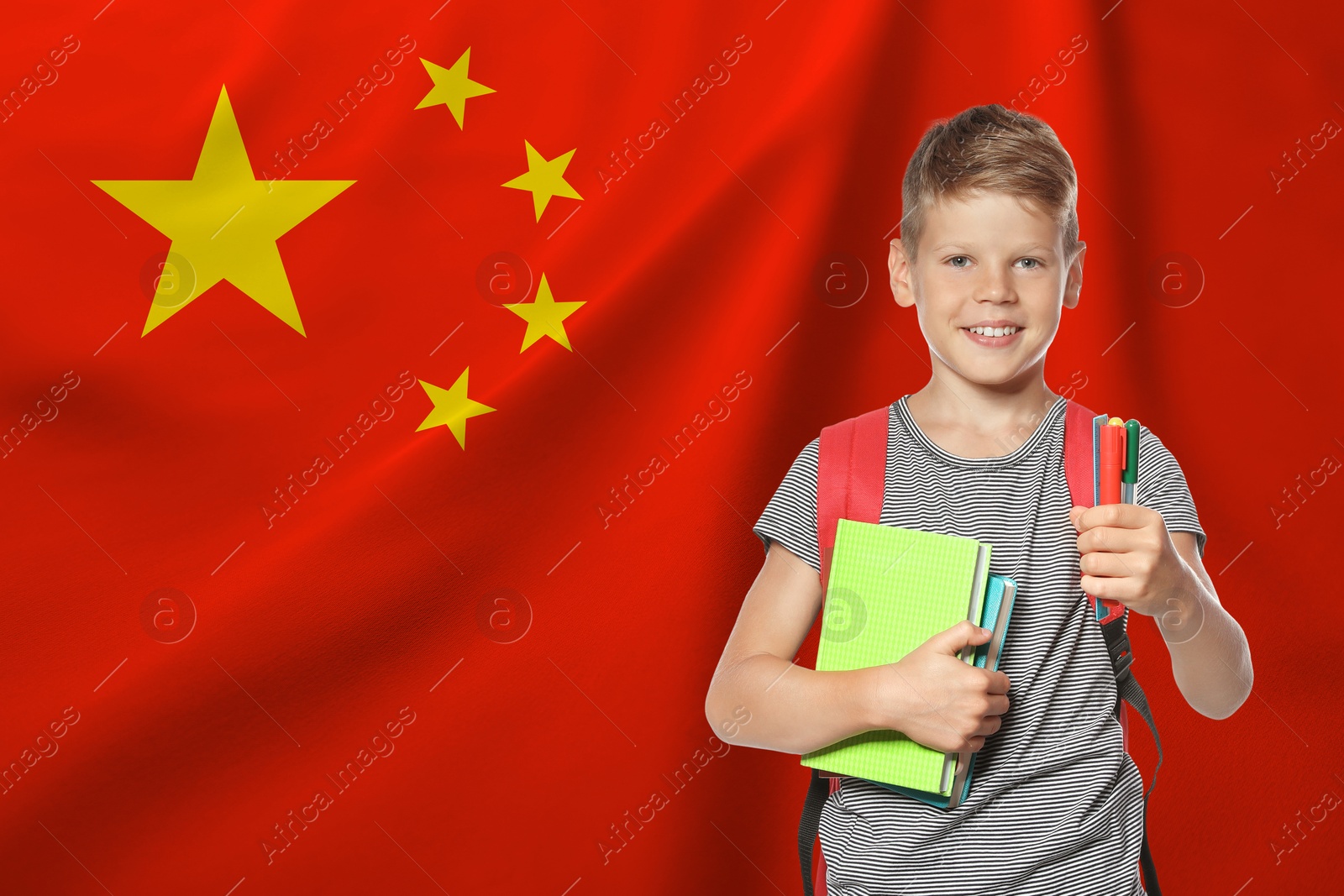 Image of Little boy with backpack and stationery against flag of China. Language school